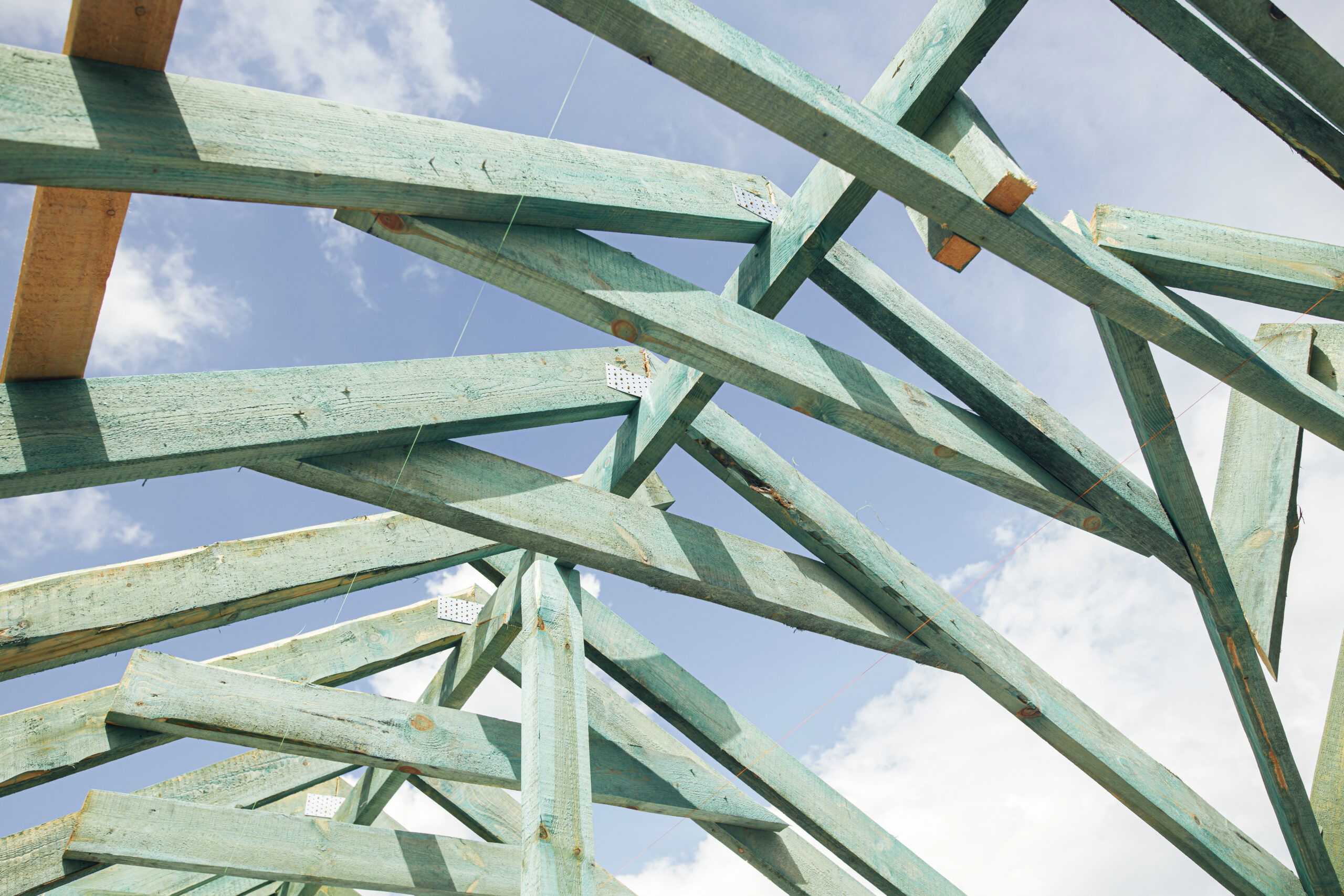 Unfinished roof trusses, view in attic with rafters and beams ag